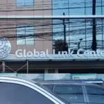 Metallic building signage for Global Link Center with globe logo, seen in Ortigas, cars parked in front. By M&G Global Ads.