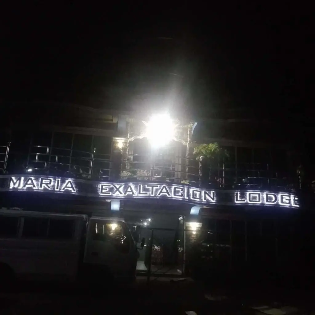 Illuminated acrylic signage for MARIA EXALTACION LODGE on building at night in Quezon City by M&G Global Ads.