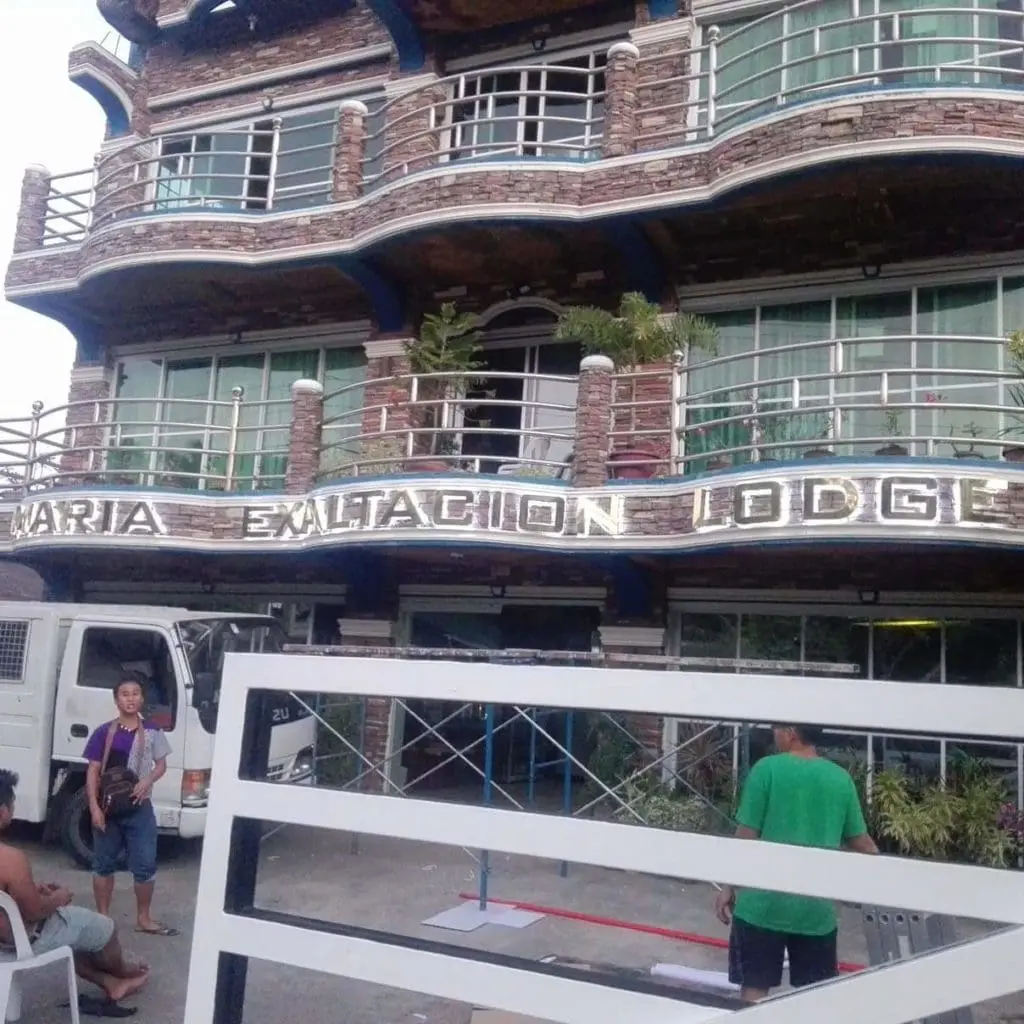 Metallic hotel signage for Maria Exaltacion Lodge, glass railings, Makati location, truck out front by M&G Global Ads.