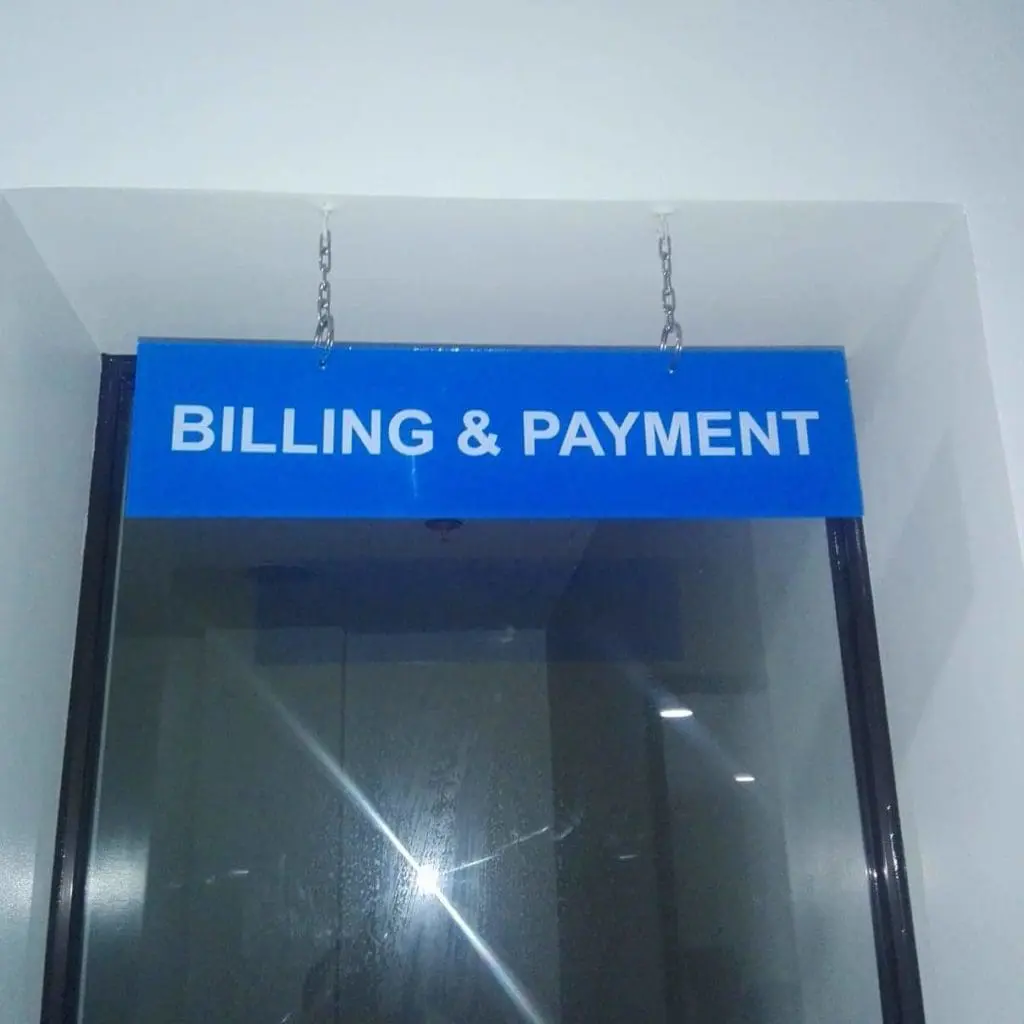 Indoor billing and payment sign hanging by chains in an office lobby, Ortigas location, by M&G Global Ads.