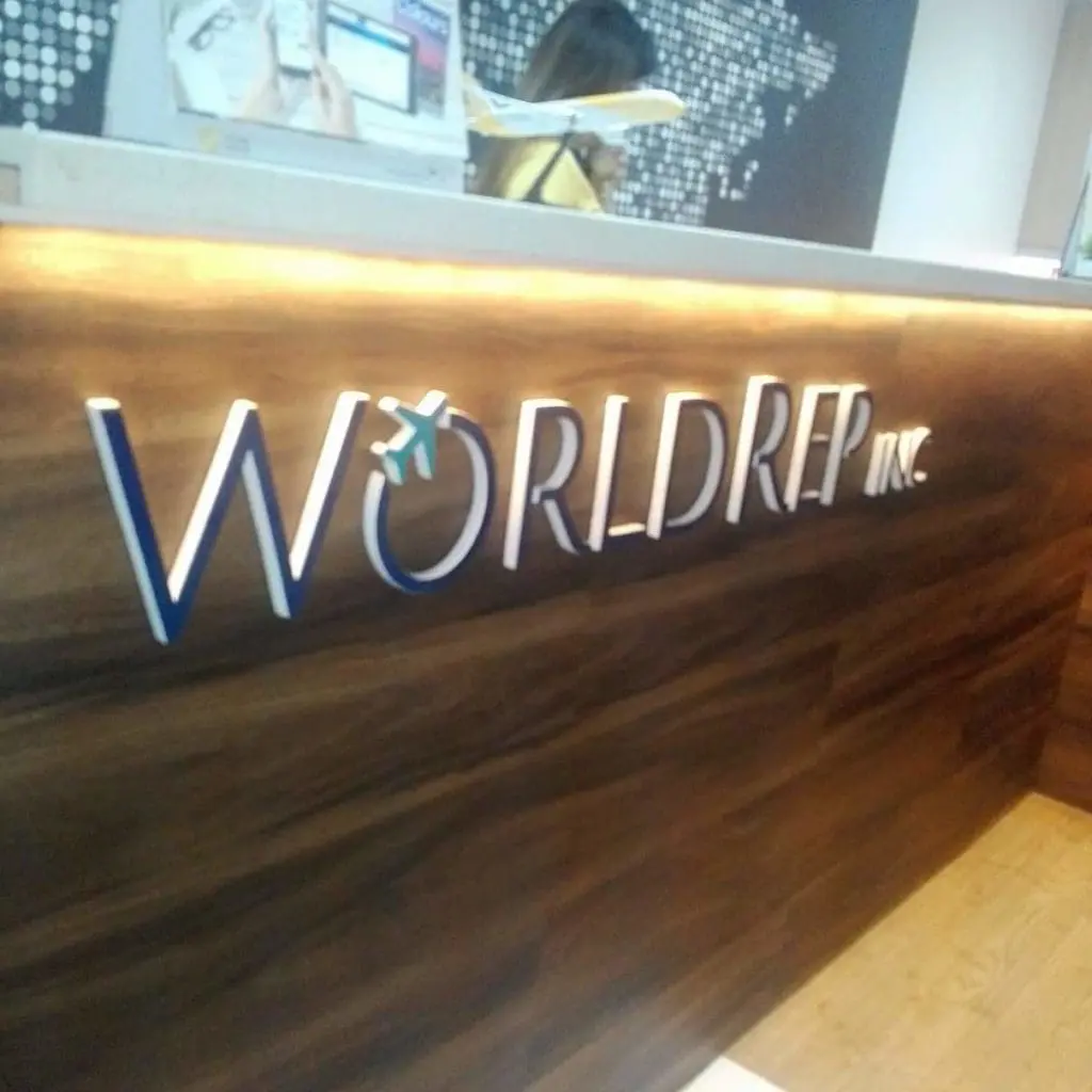 Metallic indoor reception signage for WORLDREP INC. with airplane icon, Makati office lobby by M&G Global Ads.