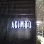 LED signage for AKIMBO in white capital letters is displayed on a black wall in Quezon City by M&G Global Ads.