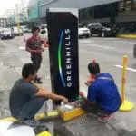 Pylon signage installation for GREENHILLS in Ortigas, with workers on-site and tools visible, by M&G Global Ads.
