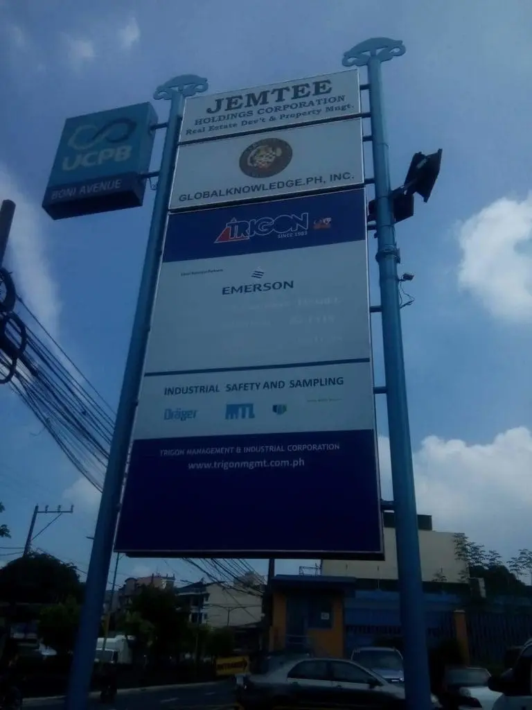 Pylon signage for JEMTEE Holding Corporation, UCPB, and Emerson in Makati with urban backdrop by M&G Global Ads.