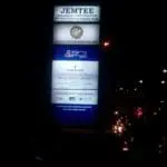 LED pylon signage for Jemtee Holdings, Global Knowledge, Emerson at night in Ortigas, glowing beside street lights by M&G Global Ads.