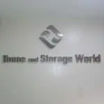 Silver 3D acrylic signage for Home and Storage World in Makati, featuring geometric logo on white wall by M&G Global Ads.