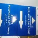 Blue acrylic wayfinding signage for Busuanga Bay Lodge near a guest notice sign in Makati, by M&G Global Ads.