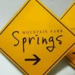 Yellow diamond wayfinding sign for Mountain Park Springs with right arrow, seen in Mandaluyong, by M&G Global Ads.