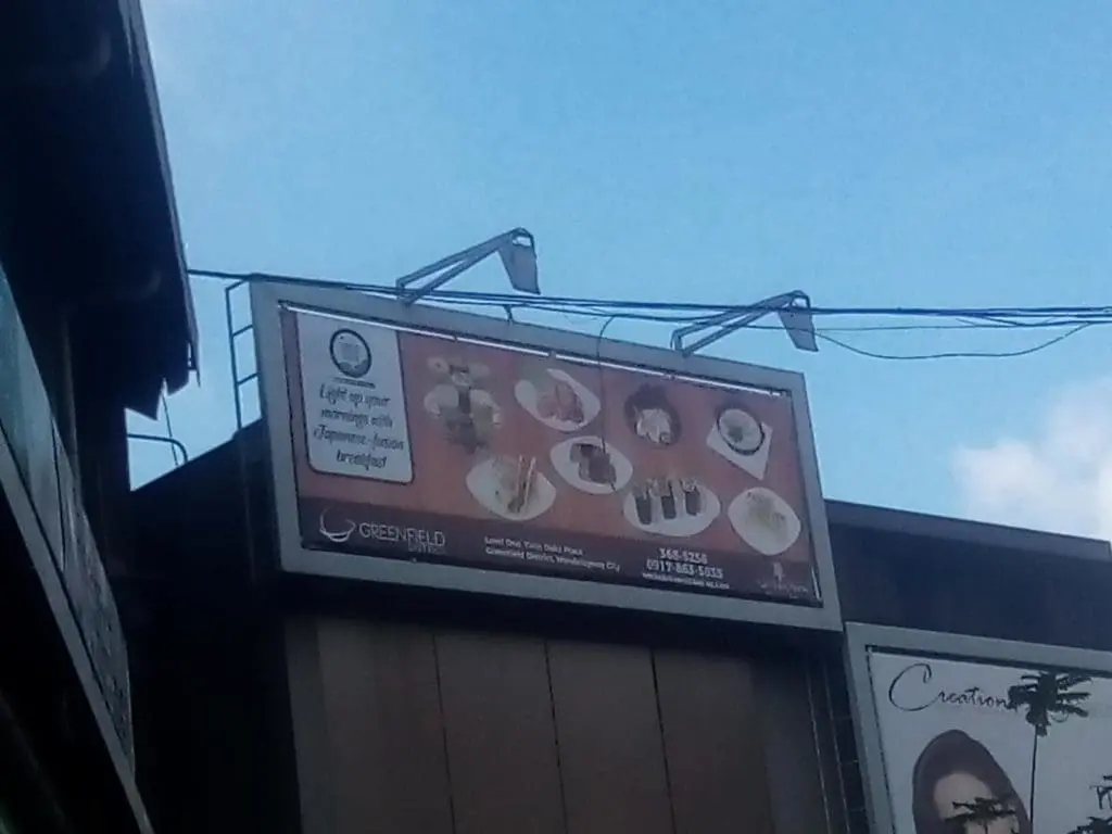 Japanese restaurant billboard signage in Quezon City with sushi and rice bowls, logo, and contact info by M&G Global Ads.
