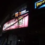 Open 24 TNC metallic storefront sign installation in Makati at night with illuminated signage by M&G Global Ads.