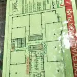 Exit evacuation plan building signage in Makati with floor layout, exits, emergency routes, and “You Are Here” by M&G Global Ads.