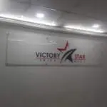 Acrylic indoor signage for Victory Star Shipping Lines in Makati, red and gray logo on white, by M&G Global Ads.