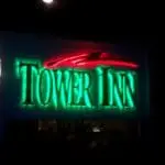 Acrylic outdoor signage for TOWER INN in green letters with red curved design, night view in Makati by M&G Global Ads.