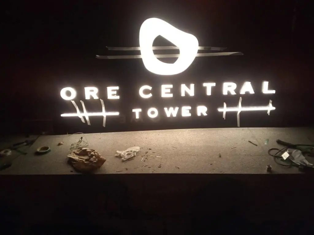 Acrylic illuminated building signage for ORE CENTRAL TOWER in BGC at night with glowing logo by M&G Global Ads.