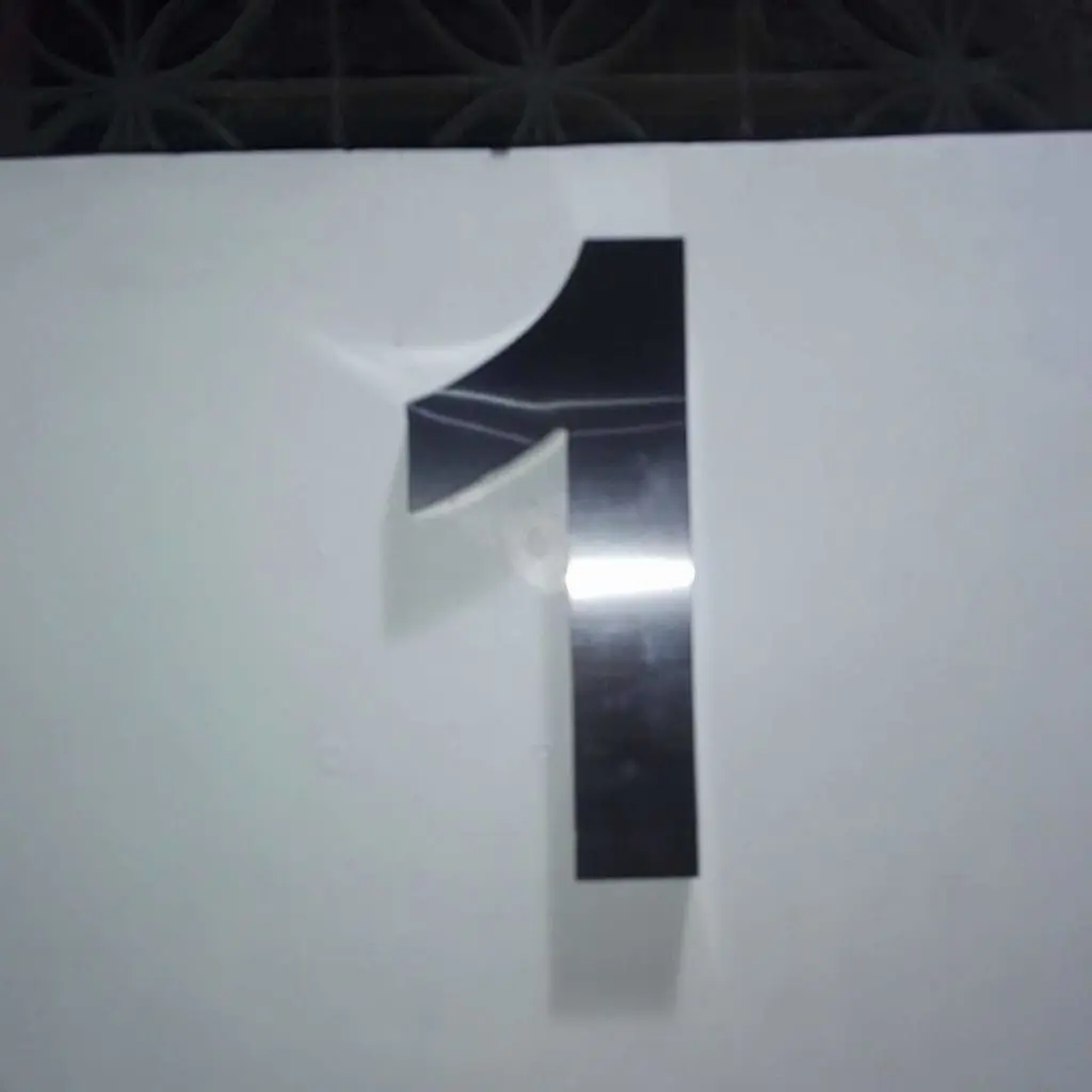 Custom metallic number one wall signage in Makati with bent upper left corner detail by M&G Global Ads.