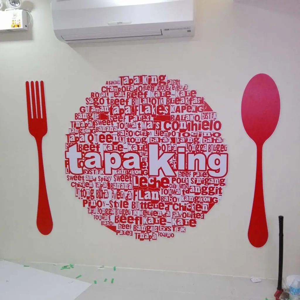 Metallic restaurant signage for Tapa King in Makati with red fork, spoon, and food plate display by M&G Global Ads.