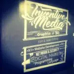 Indoor wall signage for Inventive Media in Makati, listing digital services, bold white text on dark wall by M&G Global Ads.