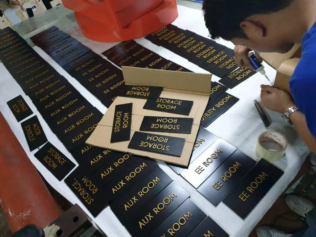 Custom black metallic indoor office signs for storage and aux rooms in Makati, with tools, by M&G Global Ads.