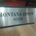 Indoor metallic room sign for Montana Bison Room in Makati, bold black letters, held by hand on table by M&G Global Ads.