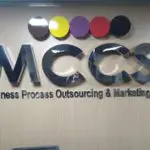 MCCS acrylic building signage with four colored circles in Ortigas for MCCS Business Process Outsourcing by M&G Global Ads.