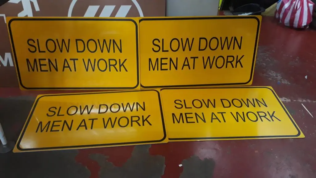 photoluminescent and evacuation map road signage for “SLOW DOWN MEN AT WORK” in Pasig, two upright and two flat, by M&G Global Ads.