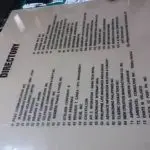 Indoor signage directory board with company names and numbers, on floor with debris, in Makati by M&G Global Ads.