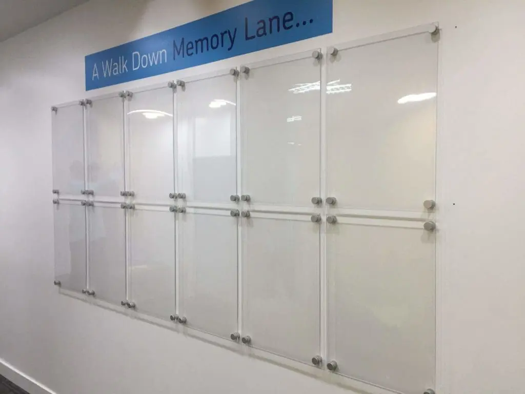 Indoor wall signage display titled A Walk Down Memory Lane with clear grid panels in a Mandaluyong hallway by M&G Global Ads.