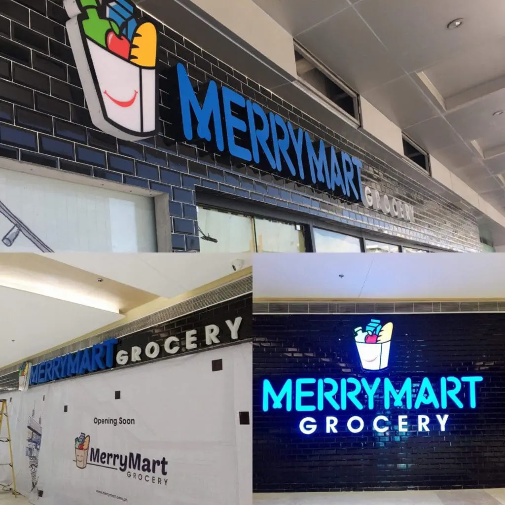 Acrylic and metallic exterior signage for MerryMart Grocery in Quezon City, grocery bag logo and blue lighting by M&G Global Ads.