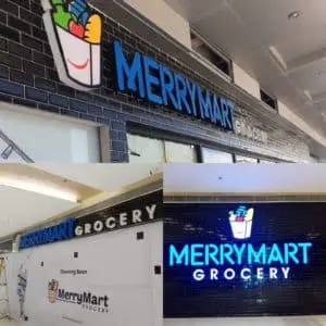 Acrylic and metallic exterior signage for MerryMart Grocery in Quezon City, grocery bag logo and blue lighting by M&G Global Ads.