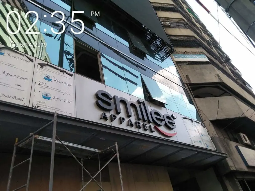 LED signage for smilee APPAREL on commercial building with scaffolding in BGC by M&G Global Ads.