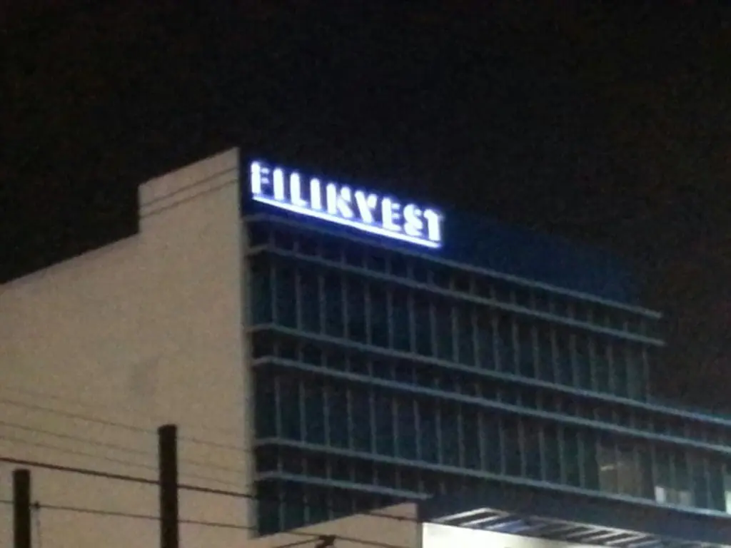 Outdoor LED rooftop signage for FILINVEST on a modern building in Ortigas, with blue window frames, by M&G Global Ads.