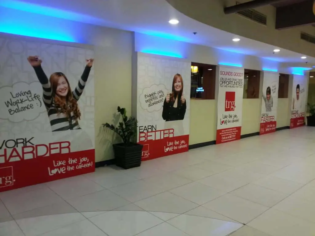 Large recruitment building signage with posters, Ortigas location, by M&G Global Ads. Smiling women with bold work messages.