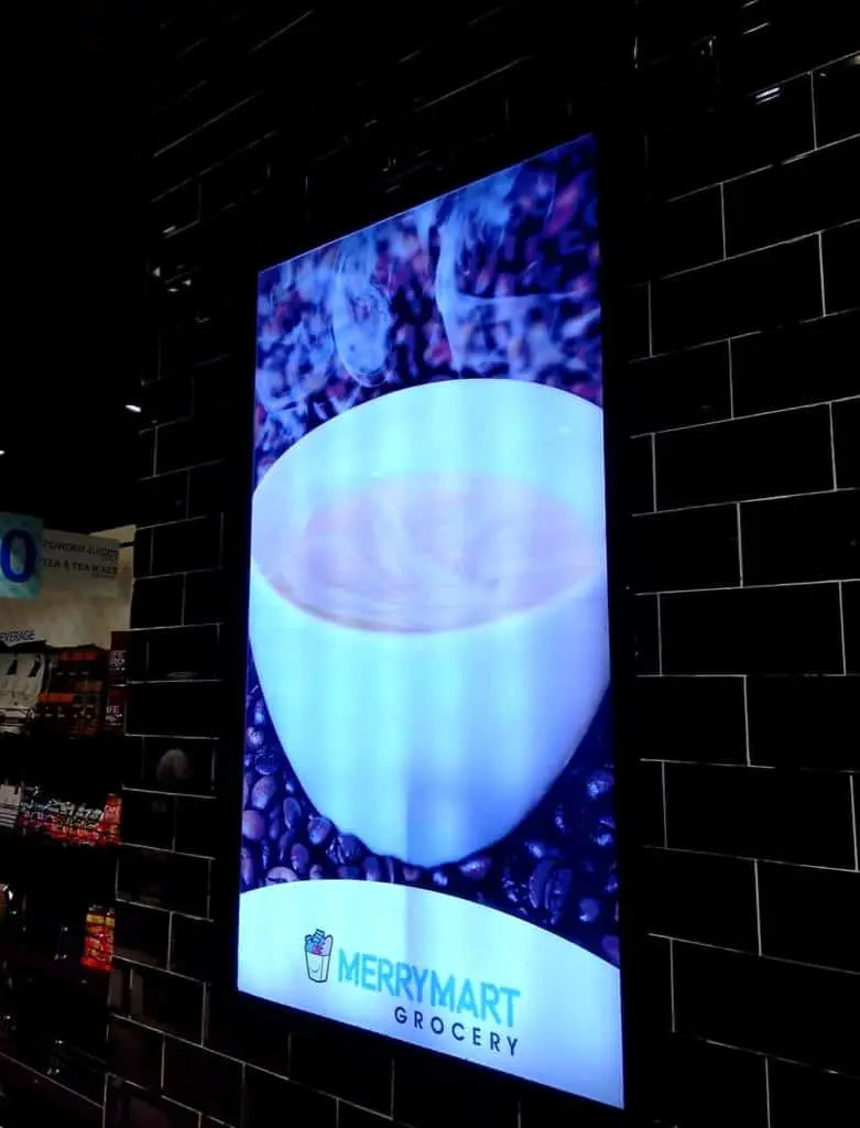 Metallic coffee shop signage for Merrymart Grocery in Makati, cup on beans design, black tiled wall by M&G Global Ads.