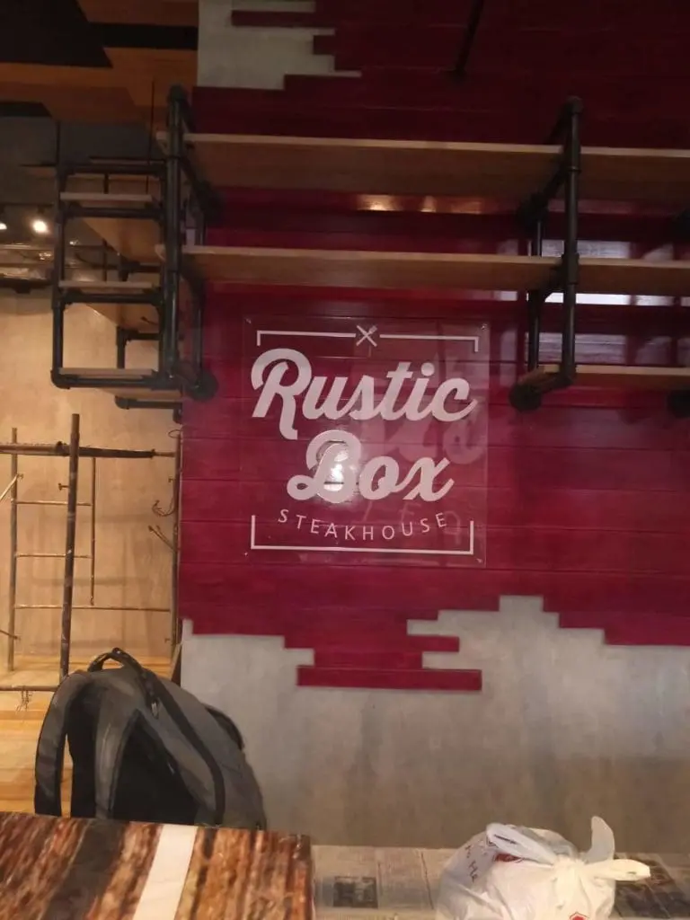 Rustic Box Steakhouse wall signage with logo and industrial decor in Makati, metal accents by M&G Global Ads.
