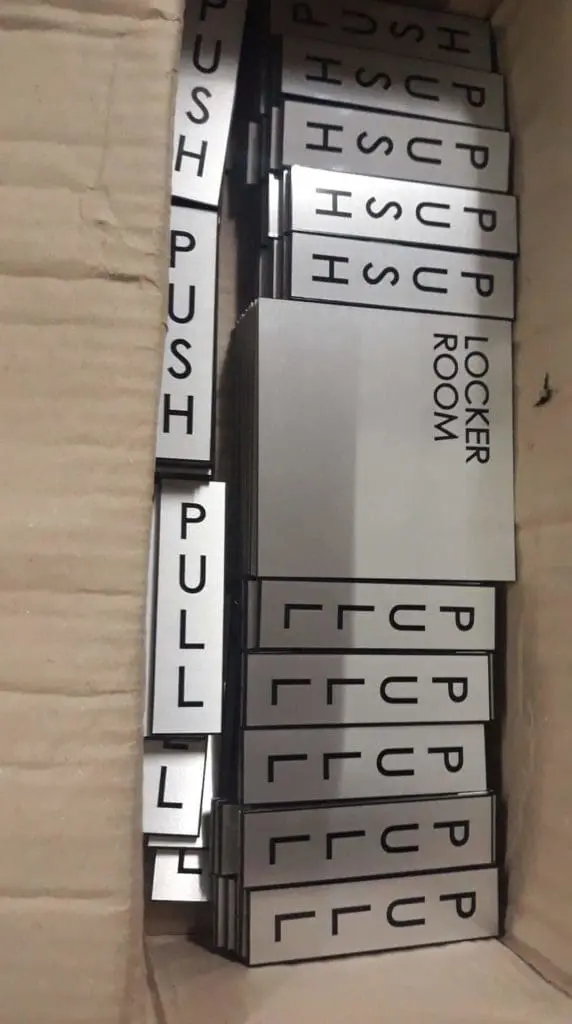 Metallic PUSH, PULL, and LOCKER ROOM door signage in a box for office use in Ortigas by M&G Global Ads.