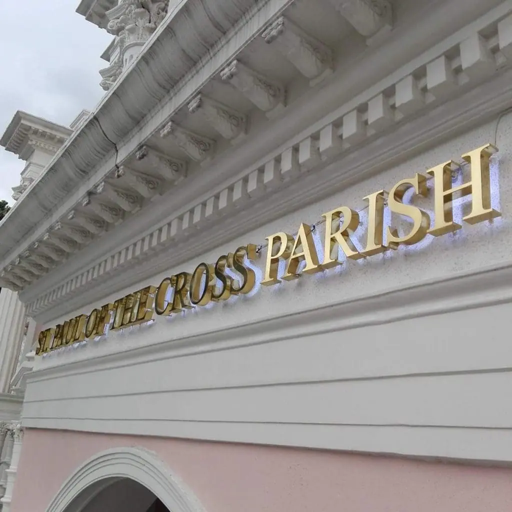 Metallic gold letter signage for St. Paul of the Cross Parish, Quezon City, above arched entrance by M&G Global Ads.