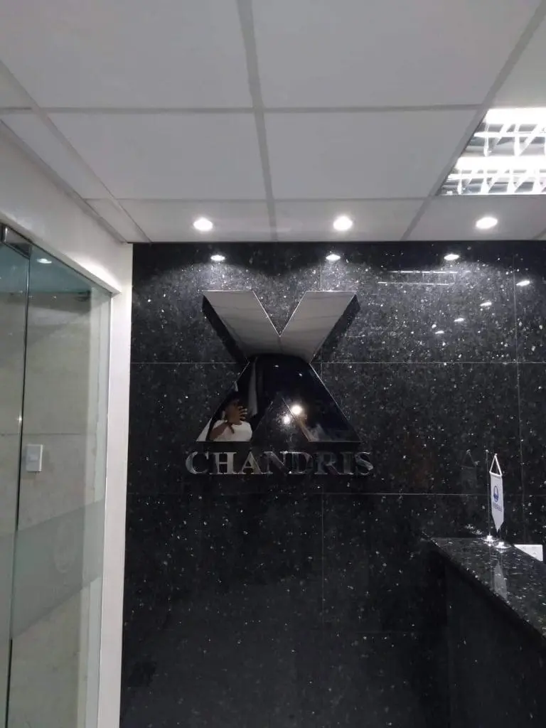 Acrylic signage for CHANDRIS with metallic X logo in a modern office lobby, Makati location, by M&G Global Ads.