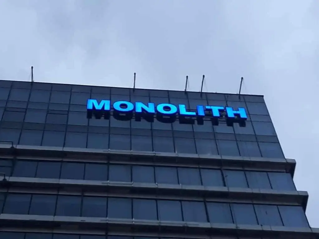LED building signage for MONOLITH on a high-rise in Ortigas, Metro Manila, with cloudy skies by M&G Global Ads.