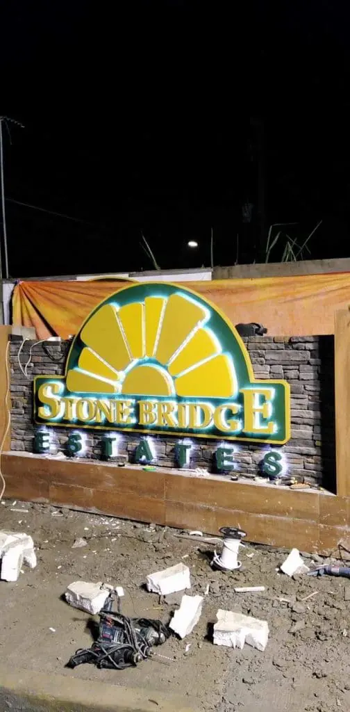 Illuminated metallic estate signage for Stonebridge in Ortigas at night, sunburst design, by M&G Global Ads.