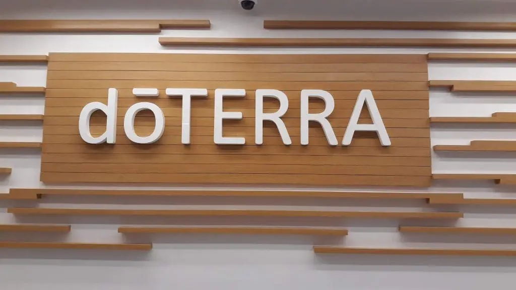Indoor wooden wall signage for doTERRA with decorative slats, displayed in Makati office interior by M&G Global Ads.
