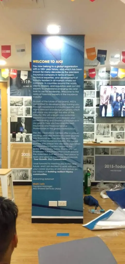 AIG acrylic office signage in Makati, showcasing global reach, with wall displays and furniture, by M&G Global Ads.