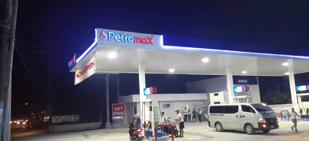 Petromax gas station with illuminated outdoor signage and Soft Opening banner in Mandaluyong at night by M&G Global Ads.