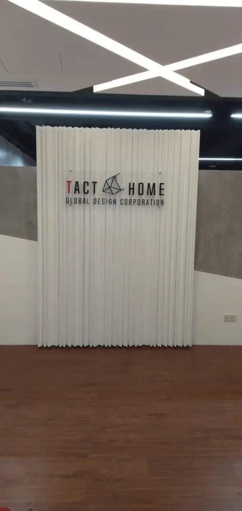 Indoor acrylic office signage for TACT HOME Global Design Corporation in Makati, mounted on a white paneled wall by M&G Global Ads.