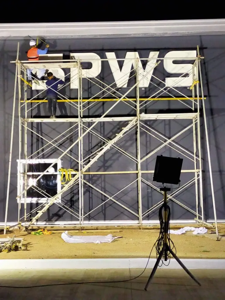 LED channel letter signage installation for PWS on building facade at night in Ortigas by M&G Global Ads.