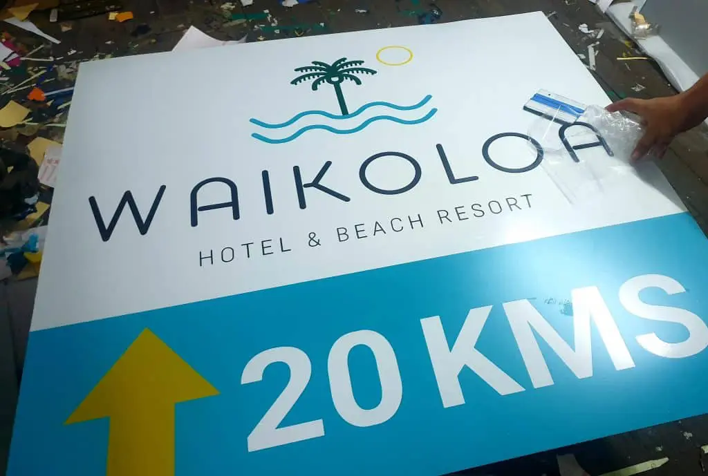 Waikoloa Hotel & Beach Resort metallic sign with palm tree, waves, sun in Makati, 20 KMS arrow. By M&G Global Ads.