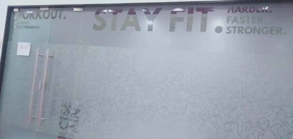 Frosted glass indoor signage door Makati, motivational STAY FIT text, metal handles, floral pattern by M&G Global Ads.