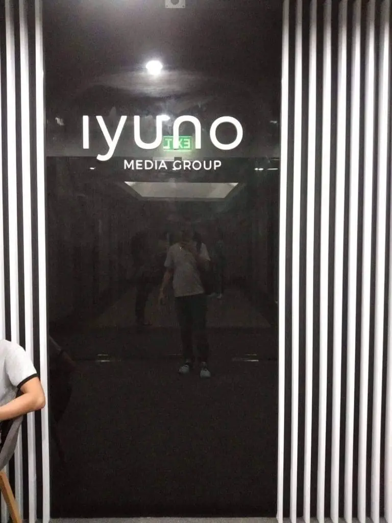Sleek metallic business sign for iyuno Media Group, Makati office; reflective wall and stripes, by M&G Global Ads.