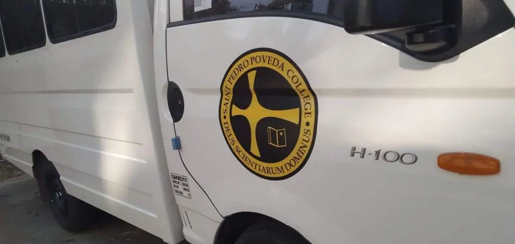 Saint Pedro Poveda College logo van near building signage in Ortigas, H-100 model, by M&G Global Ads.