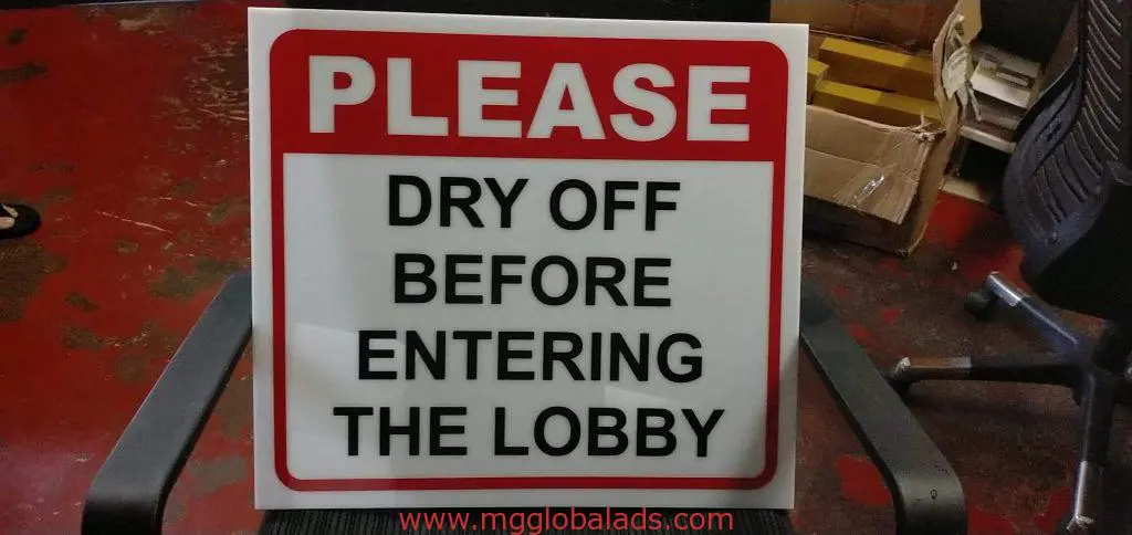 Acrylic indoor signage for lobby, bold red PLEASE, Makati office scene with supplies in background by M&G Global Ads.