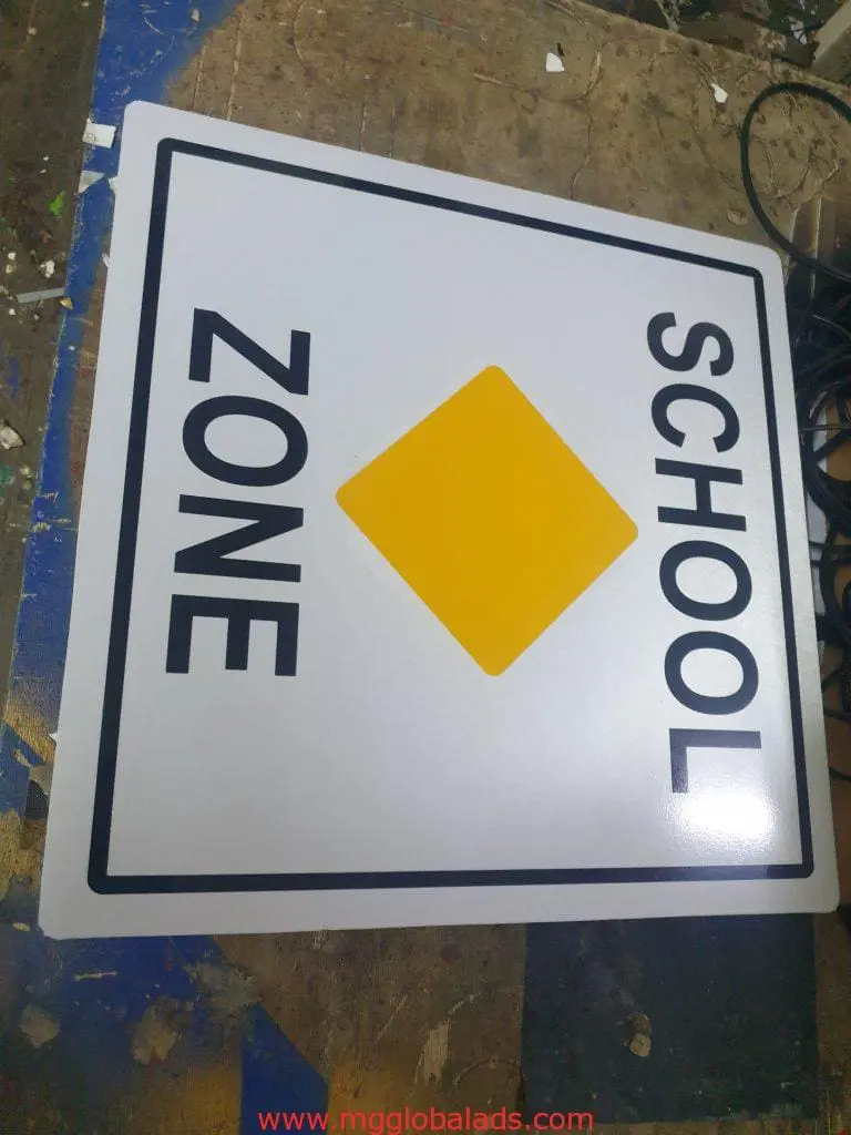 SCHOOL ZONE metallic safety signage on workbench with materials in Makati by M&G Global Ads.